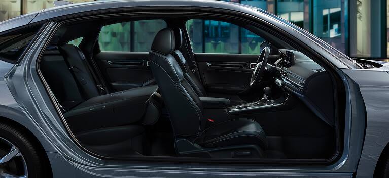 2027 Honda Civic Hatchback Touring Hybrid leather-trimmed seats with rear seat folded down (Compact Hatchback).